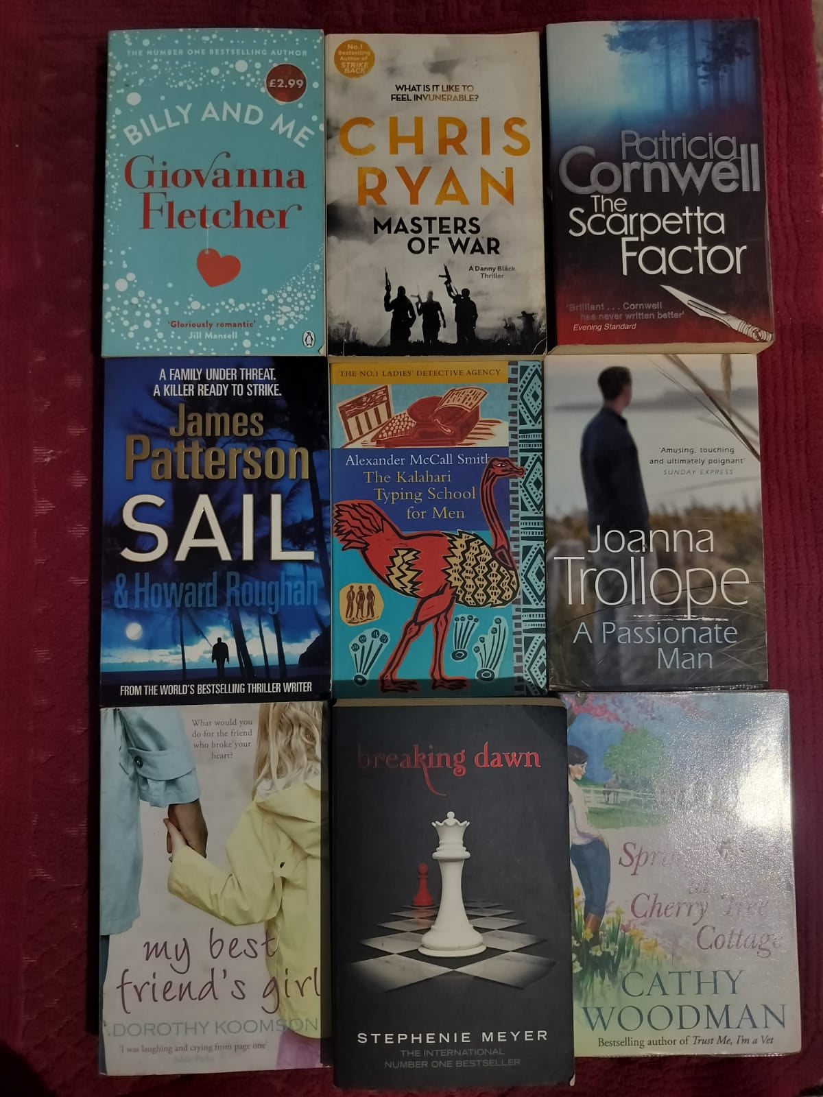 Collection of books with various covers on a red background

